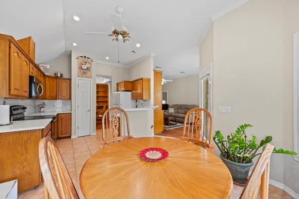a very nice looking dining room with kitchen island furniture and a chandelier