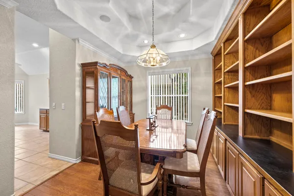 a view of a dining room with furniture and a chandelier