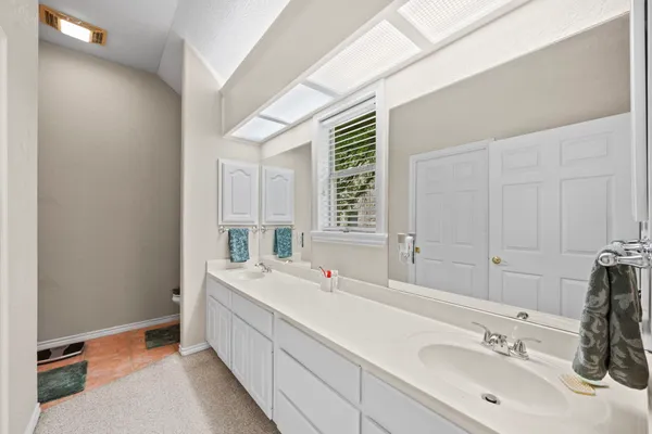 a bathroom with a double vanity sink mirror and