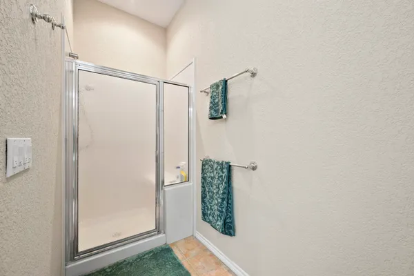 a bathroom with a shower and a window
