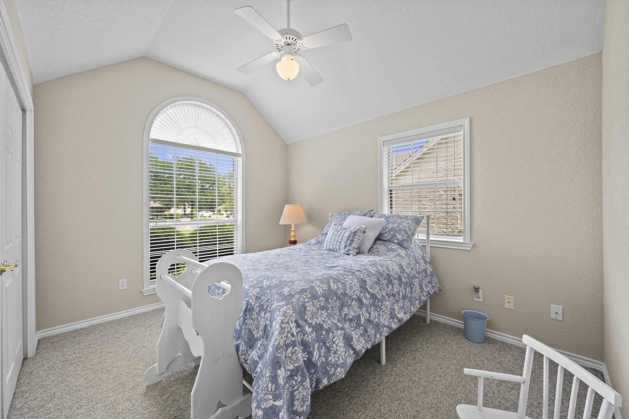 107 Stacey Cove Georgetown, TX 78628 - Photo 16 of 29 a bedroom with a bed and a chandelier