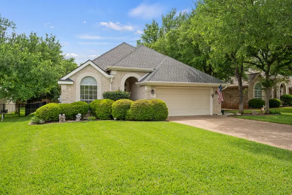 a front view of house with yard and green space