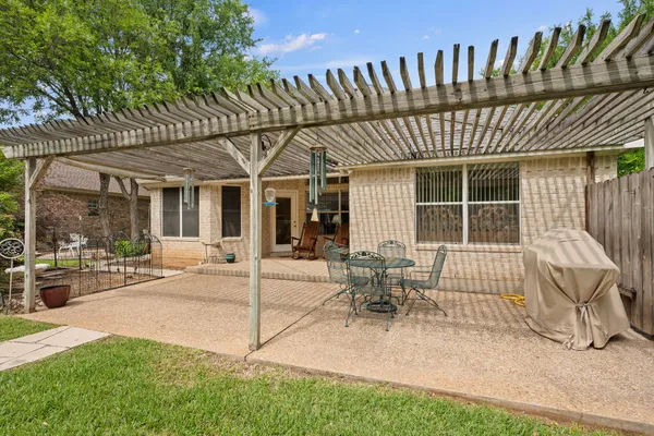a view of a house with backyard porch and sitting area