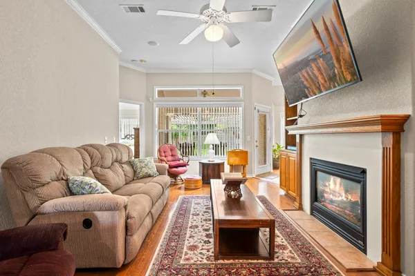 a living room with furniture large window and a fireplace