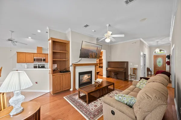 a living room with furniture a fireplace and a flat screen tv
