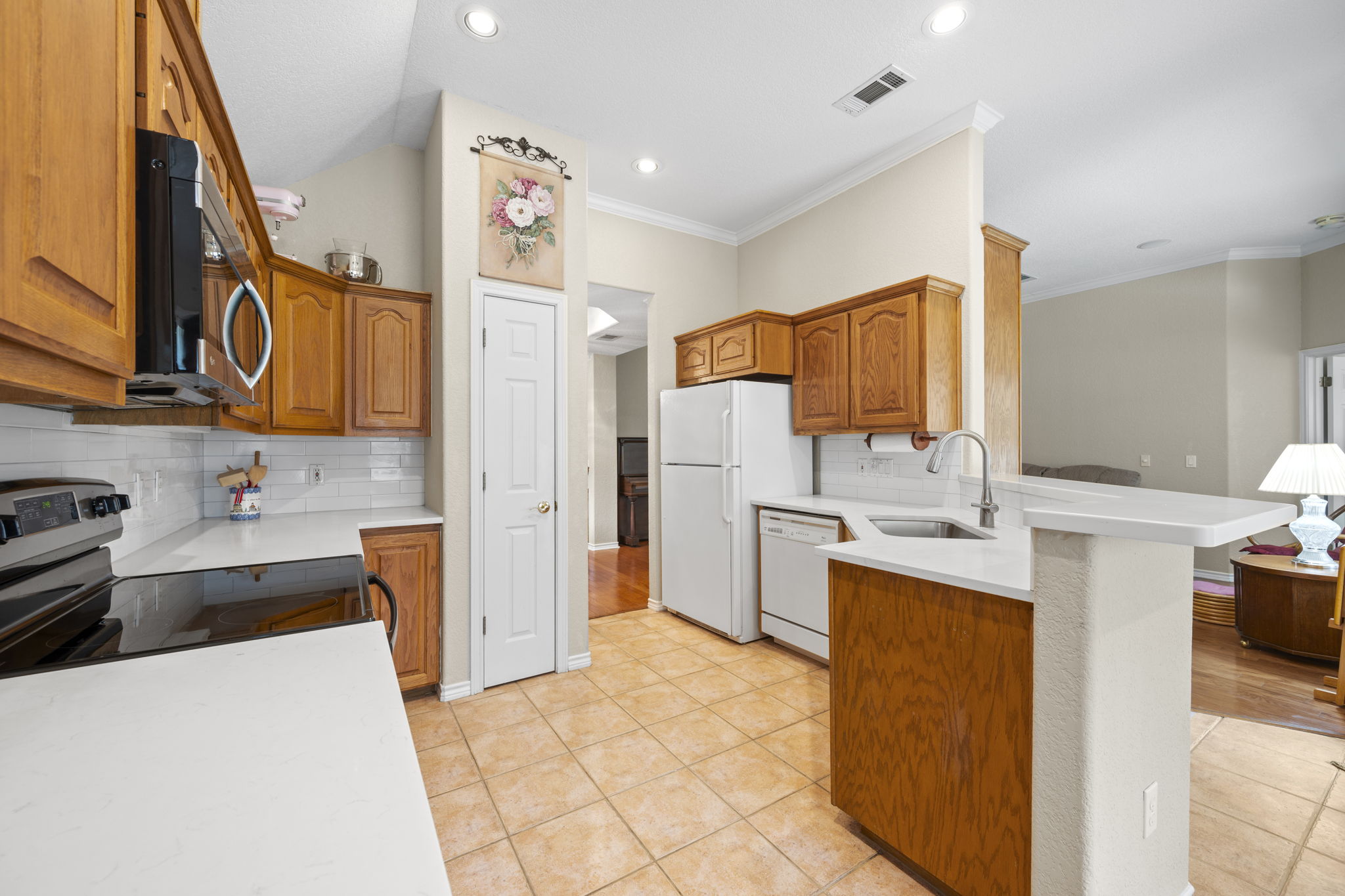 107 Stacey Cove Georgetown, TX 78628 - Photo 9 of 29 a kitchen with stainless steel appliances a stove refrigerator sink and cabinets