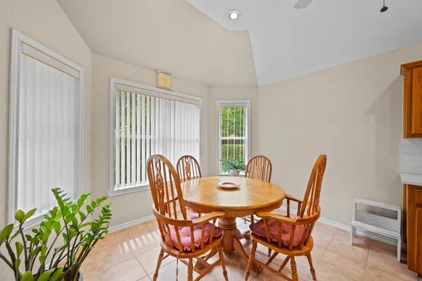 a dining room with furniture and wooden floor