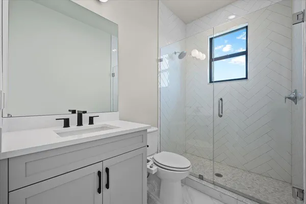 a spacious bathroom with a double vanity sink mirror and shower