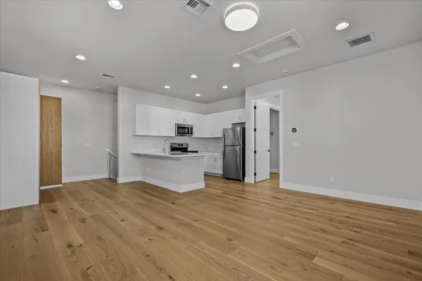 a living room with furniture a rug and a flat screen tv