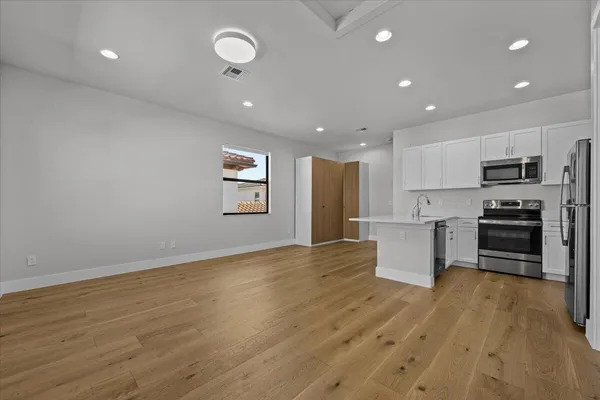 a living room filled with furniture and a flat screen tv