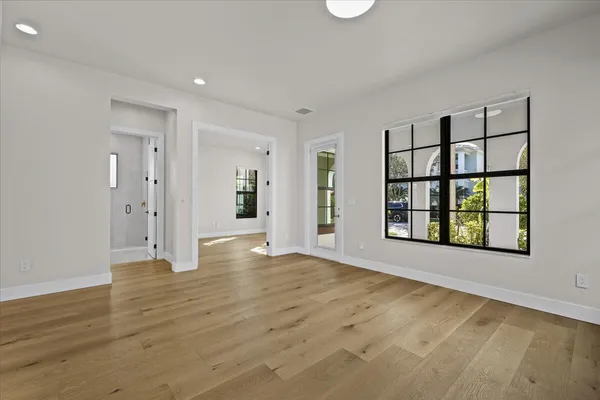 wooden floor in an empty room with a window