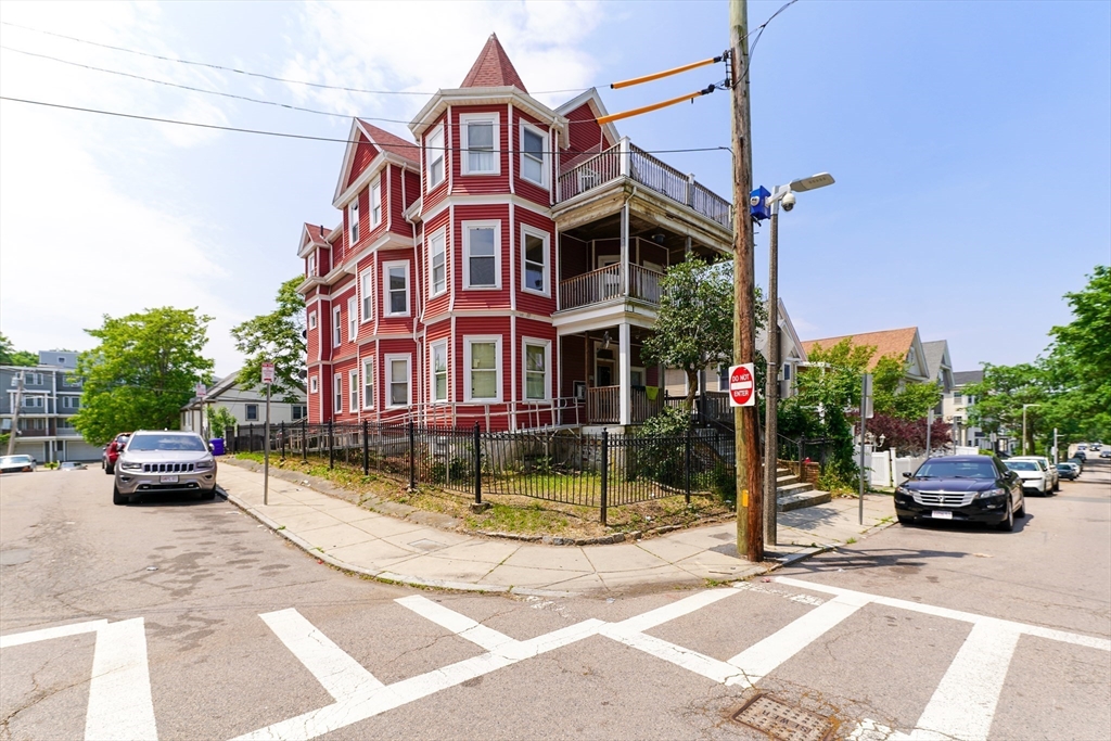 107 Devon Street Boston, MA 02121 - Photo 3 of 9 a view of a brick building with a yard in front of it