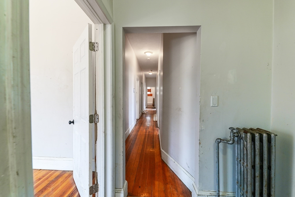 107 Devon Street Boston, MA 02121 - Photo 5 of 9 a view of a hallway with a livingroom and stairs