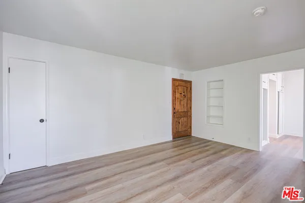 a view of an empty room and wooden floor