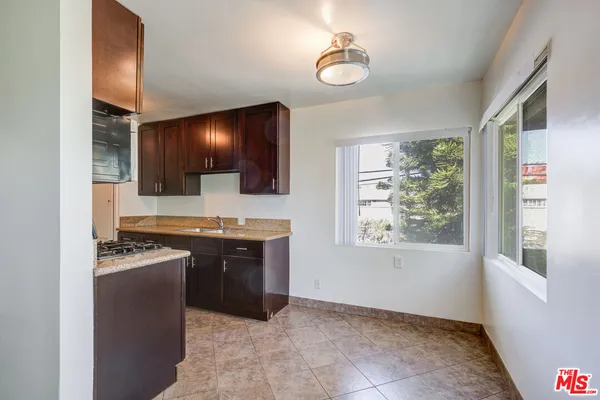 a kitchen with stainless steel appliances granite countertop a sink and a stove