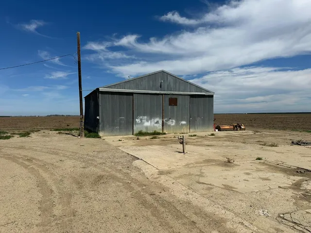a view of a house with swimming pool and sitting area