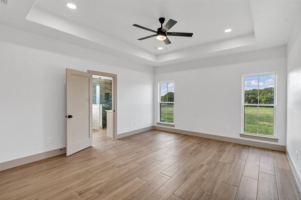 5006 Stover Way Granbury, TX 76049 - Photo 23 of 40 a view of an empty room with wooden floor and a window