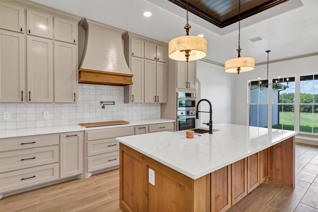 5006 Stover Way Granbury, TX 76049 - Photo 9 of 40 a kitchen that has cabinets a sink and a stove
