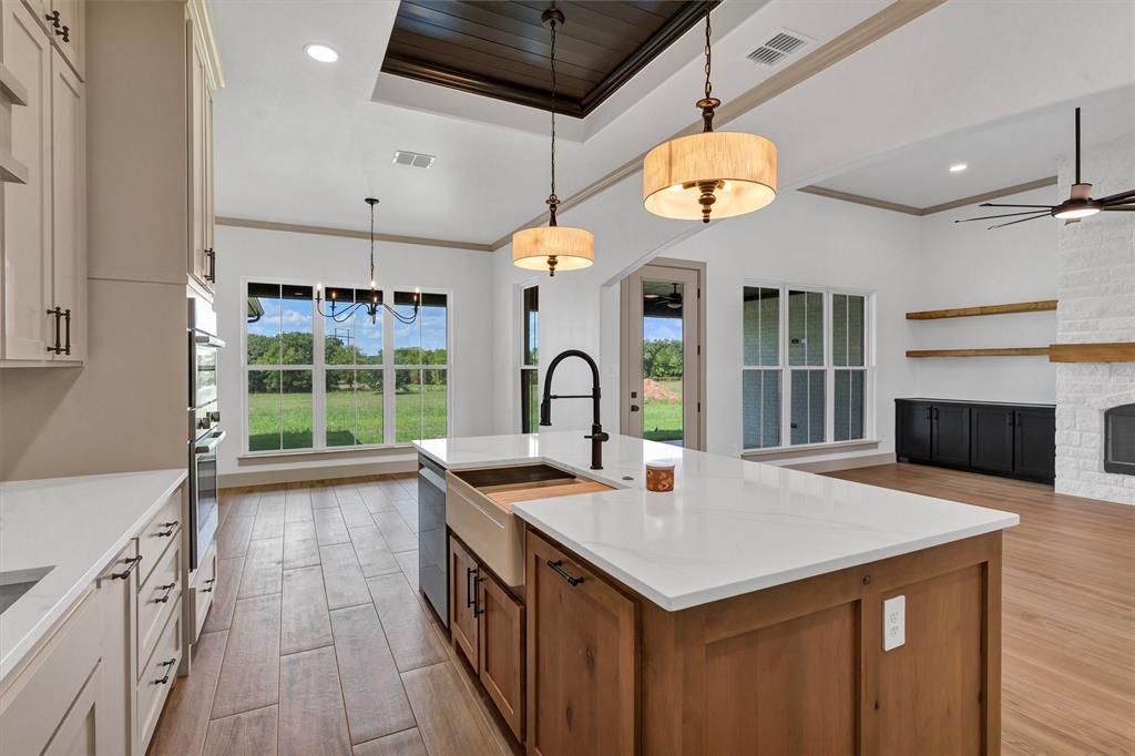 5006 Stover Way Granbury, TX 76049 - Photo 10 of 40 a kitchen with a stove and a sink