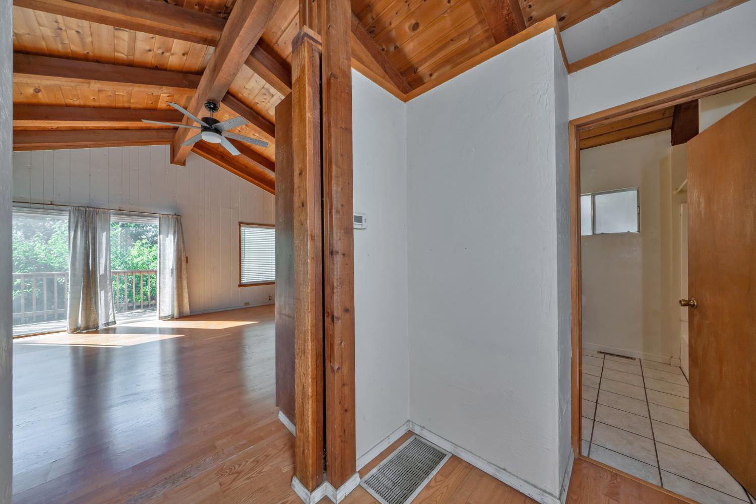 6426 Sly Park Road Placerville, CA 95667 - Photo 14 of 32 a view of an empty room with wooden floor and a window
