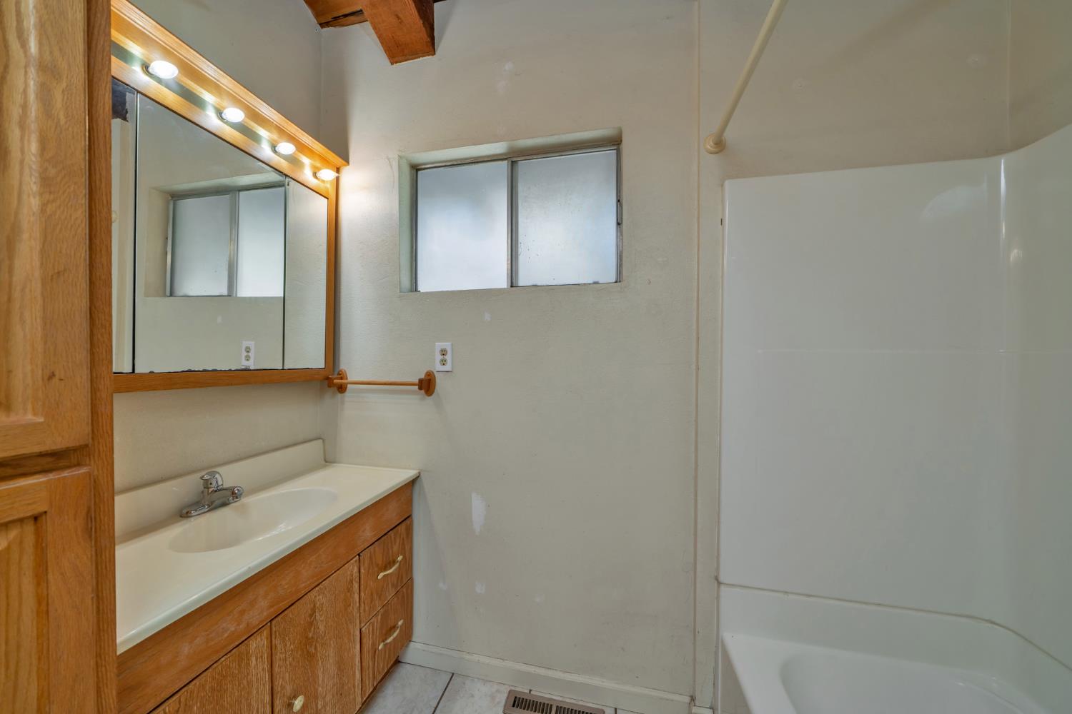 6426 Sly Park Road Placerville, CA 95667 - Photo 16 of 32 a bathroom with a sink and mirror