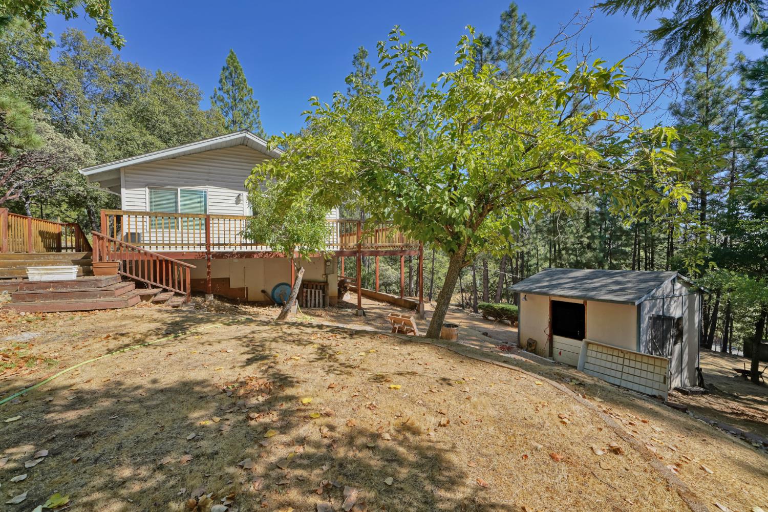 6426 Sly Park Road Placerville, CA 95667 - Photo 23 of 32 a backyard of a house with table and chairs