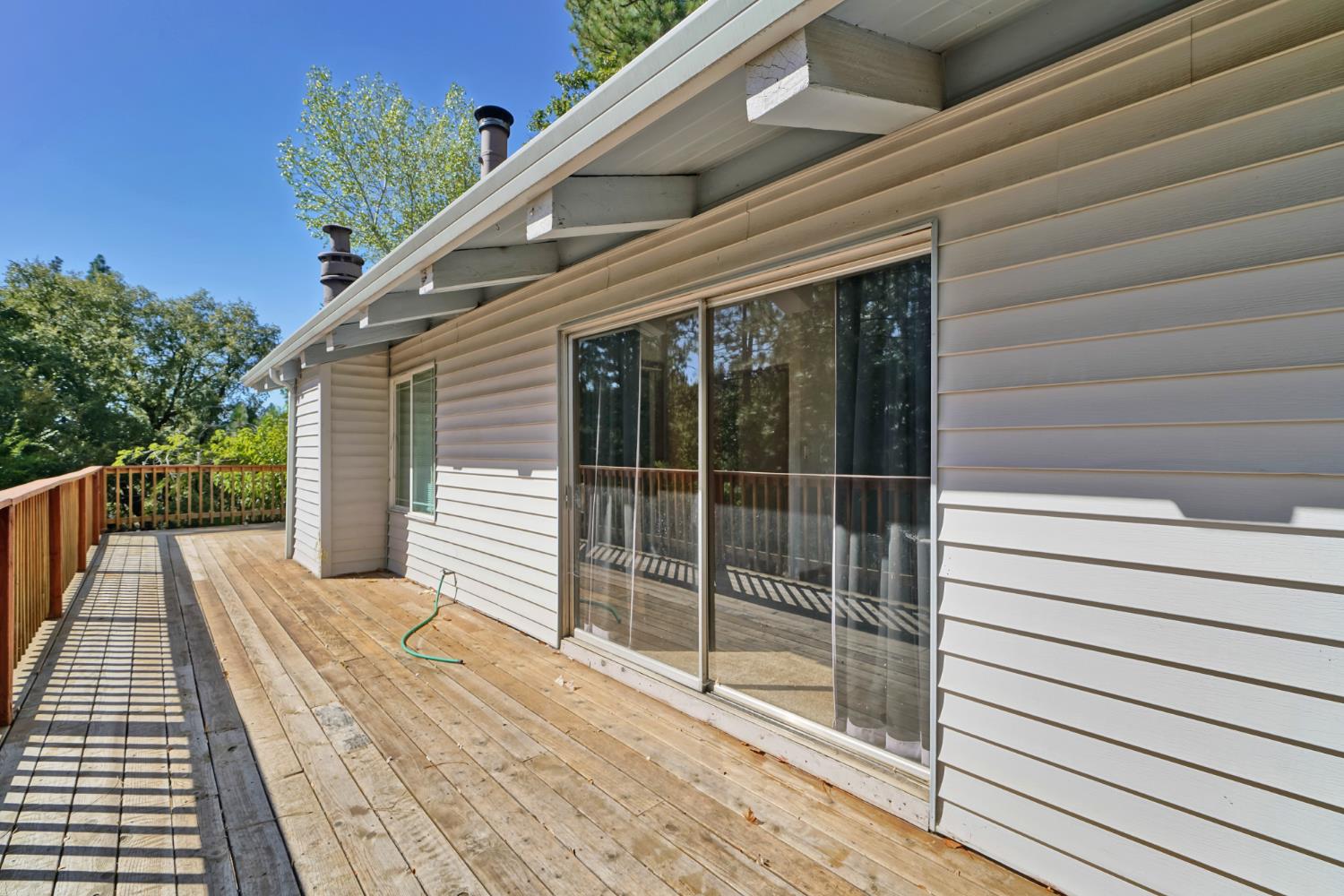 6426 Sly Park Road Placerville, CA 95667 - Photo 5 of 32 a view of a balcony with wooden floor and floor to ceiling window