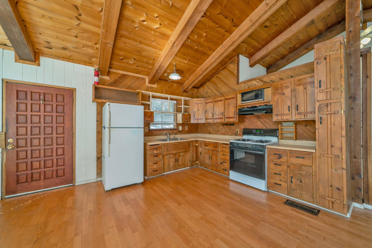 6426 Sly Park Road Placerville, CA 95667 - Photo 7 of 32 a kitchen with cabinets and wooden floor