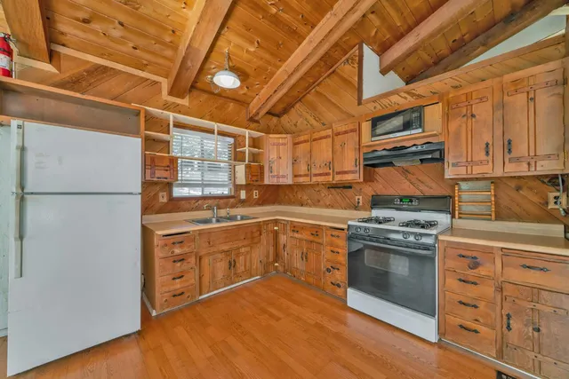 a view of a kitchen with a sink and a stove top oven