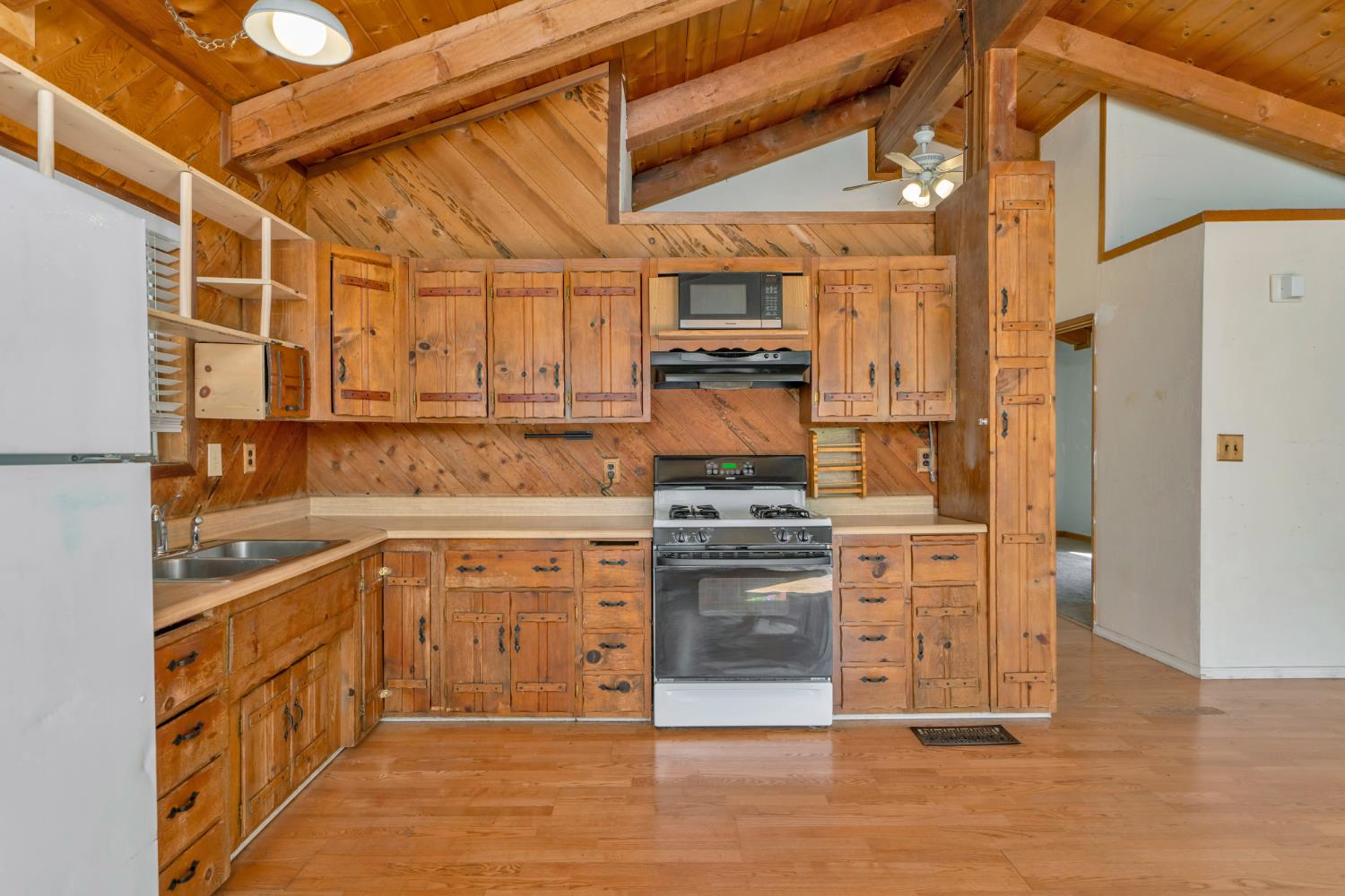 6426 Sly Park Road Placerville, CA 95667 - Photo 10 of 32 a kitchen with stainless steel appliances a stove a refrigerator and cabinets