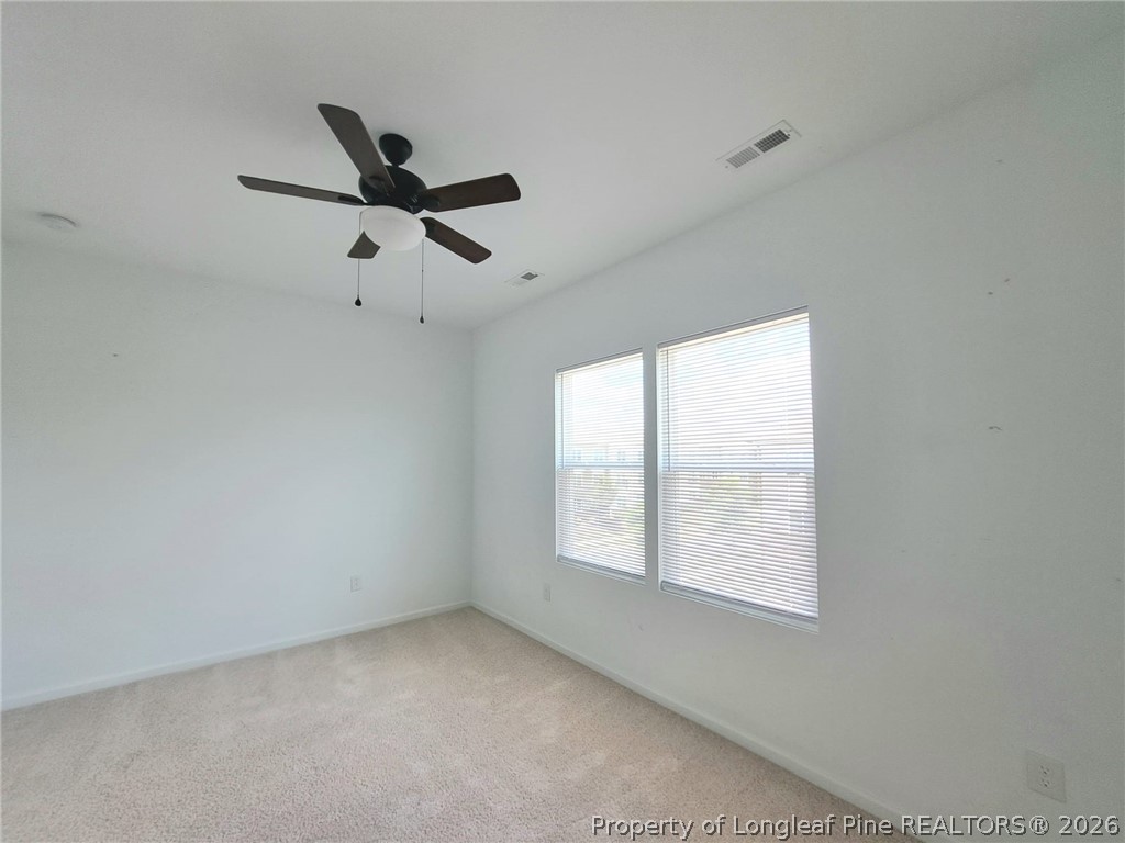 1939 Robin Hill Lane Raleigh, NC 27610 - Photo 16 of 25 an empty room with a window and a fan