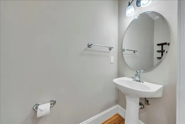 a bathroom with a sink a mirror and vanity