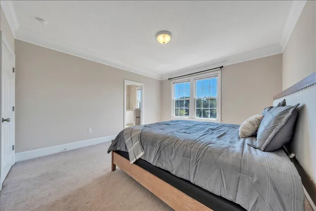 a bed sitting in a bedroom next to a window