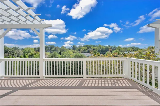 a view of a balcony with wooden floor