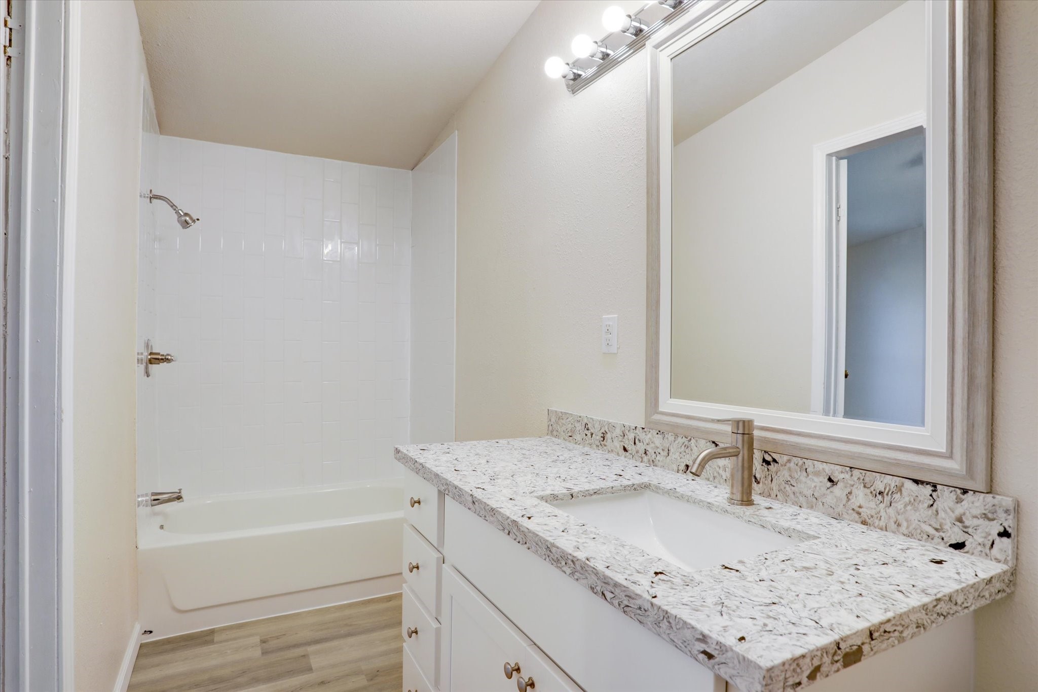 5806 Highway 35 Angleton, TX 77515 - Photo 14 of 35 The primary bath offers a nice granite vanity with a tub shower combonation.