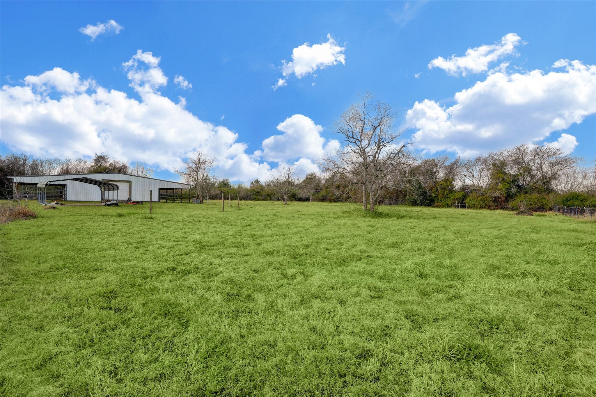 5806 Highway 35 Angleton, TX 77515 - Photo 26 of 35 This is a view from the back of the house towards the barn and covered parking area.