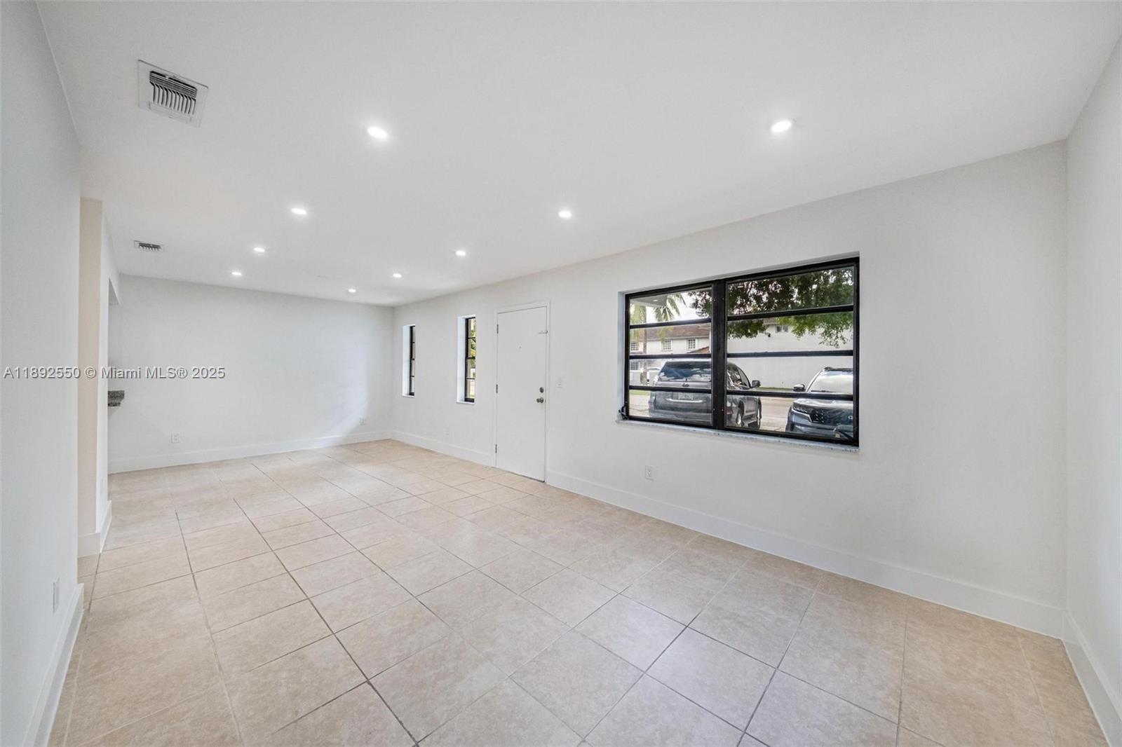 1283 West 42nd Street Hialeah, FL 33012 - Photo 11 of 54 an empty room with windows and ceiling fan