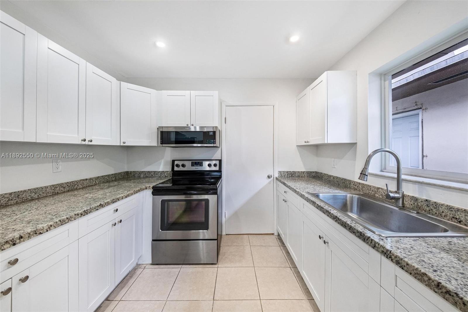 1283 West 42nd Street Hialeah, FL 33012 - Photo 16 of 54 a kitchen with stainless steel appliances granite countertop a sink stove and cabinets
