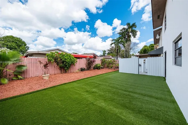 a view of a house with a backyard