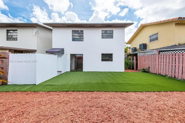 a view of a backyard with a small barn