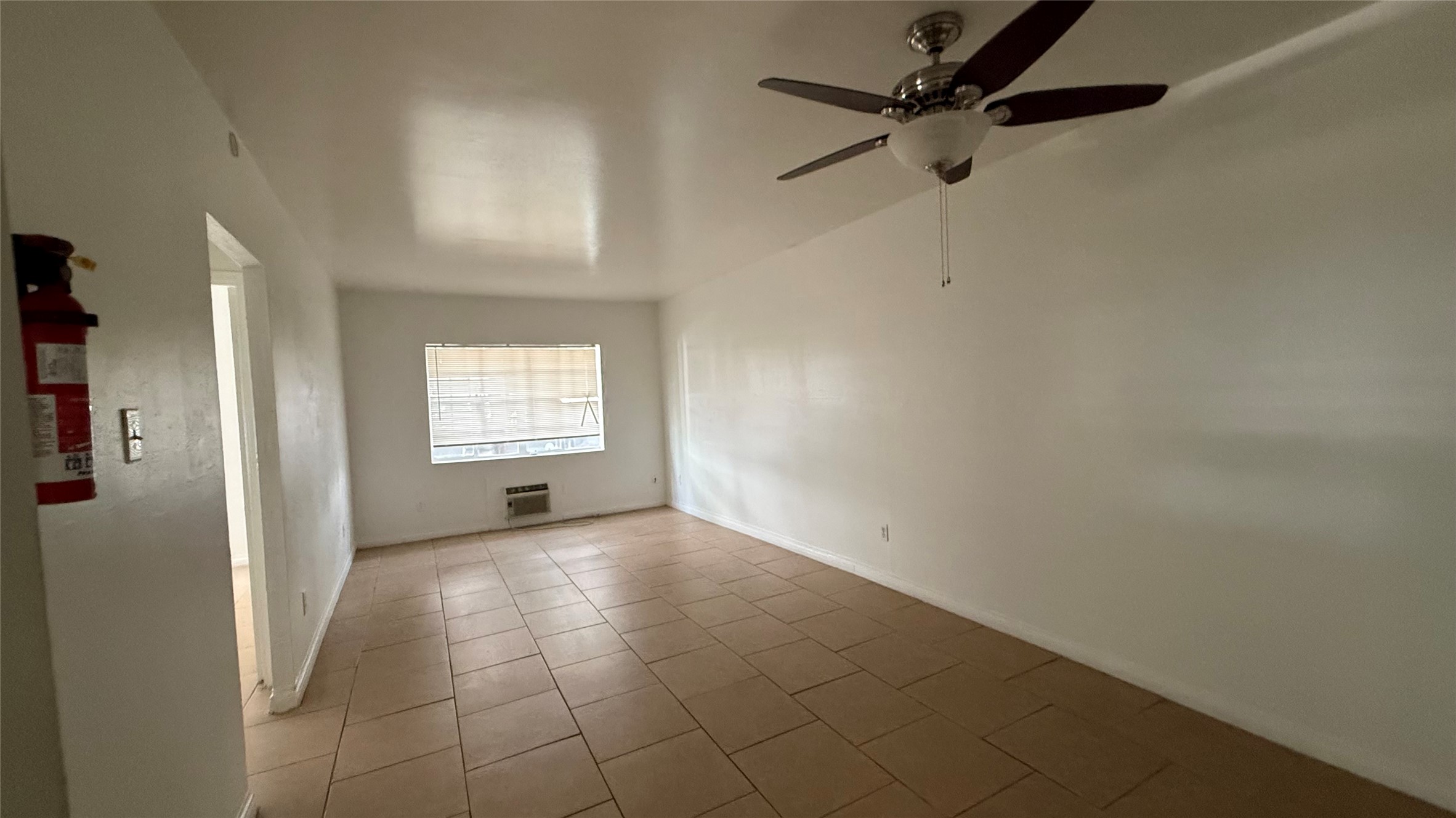 5611 Jackson Street, Unit 1 Houston, TX 77004 - Photo 2 of 5 an empty room with windows and fan