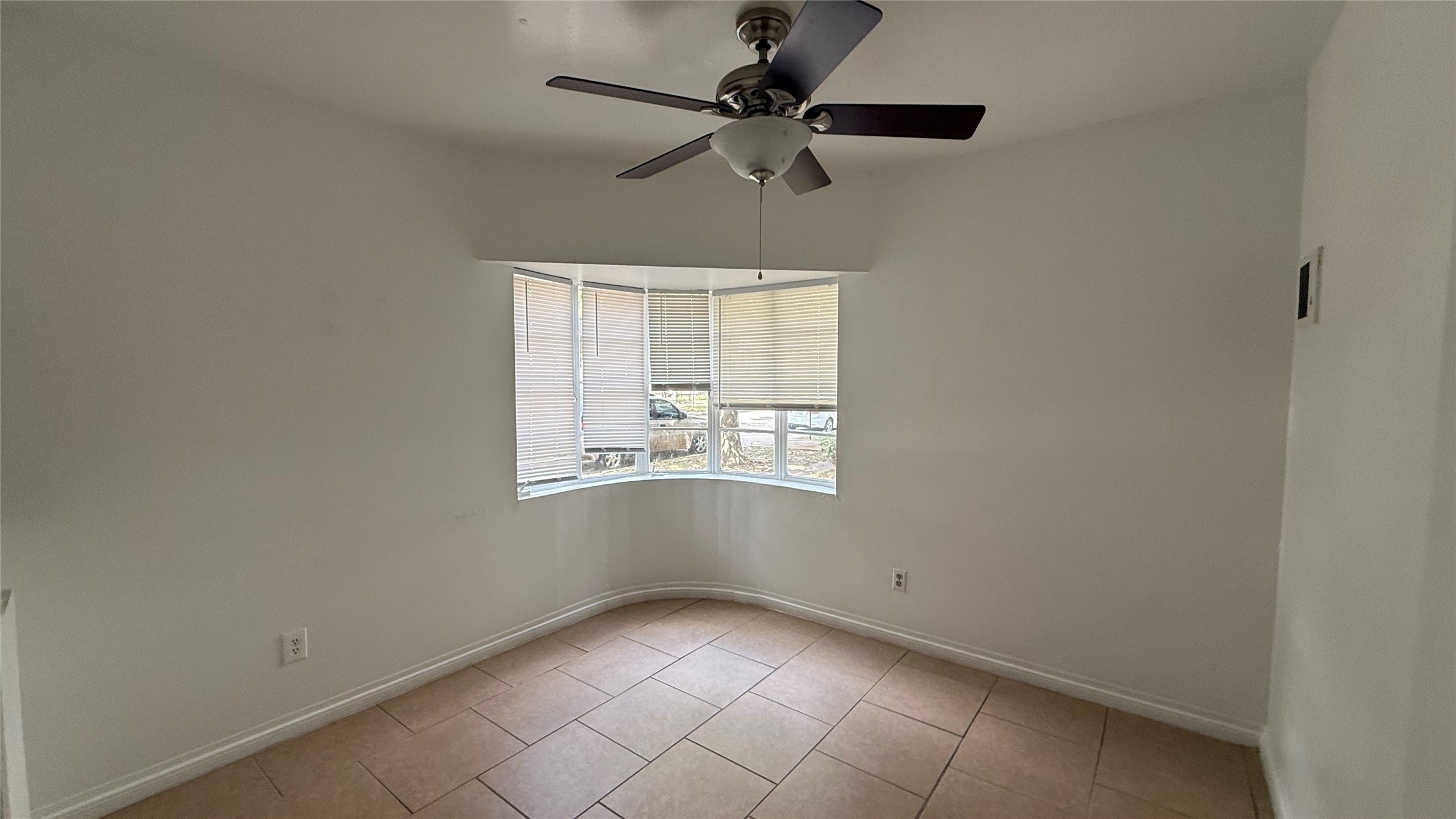 5611 Jackson Street, Unit 1 Houston, TX 77004 - Photo 3 of 7 an empty room with a window and a fan