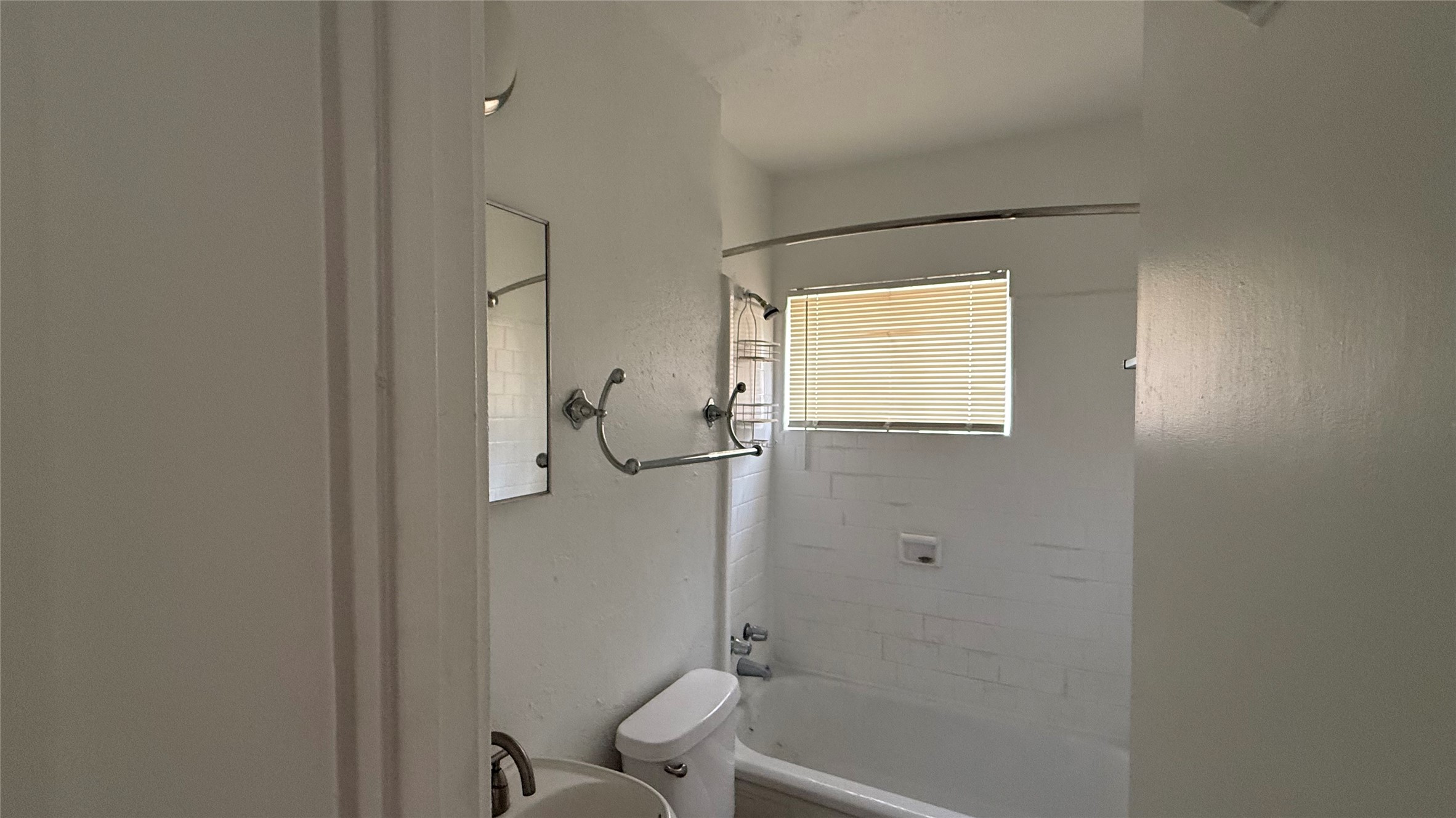 5611 Jackson Street, Unit 1 Houston, TX 77004 - Photo 4 of 7 a bathroom with a granite countertop sink a toilet and shower