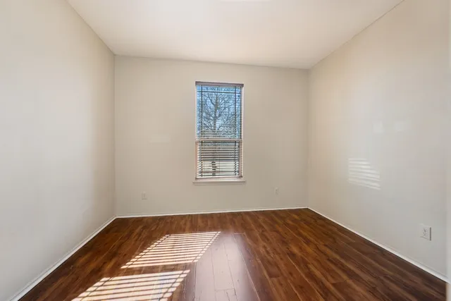 a view of a room with wooden floor and window