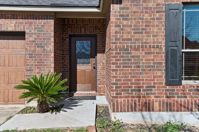 a brick building with a small yard