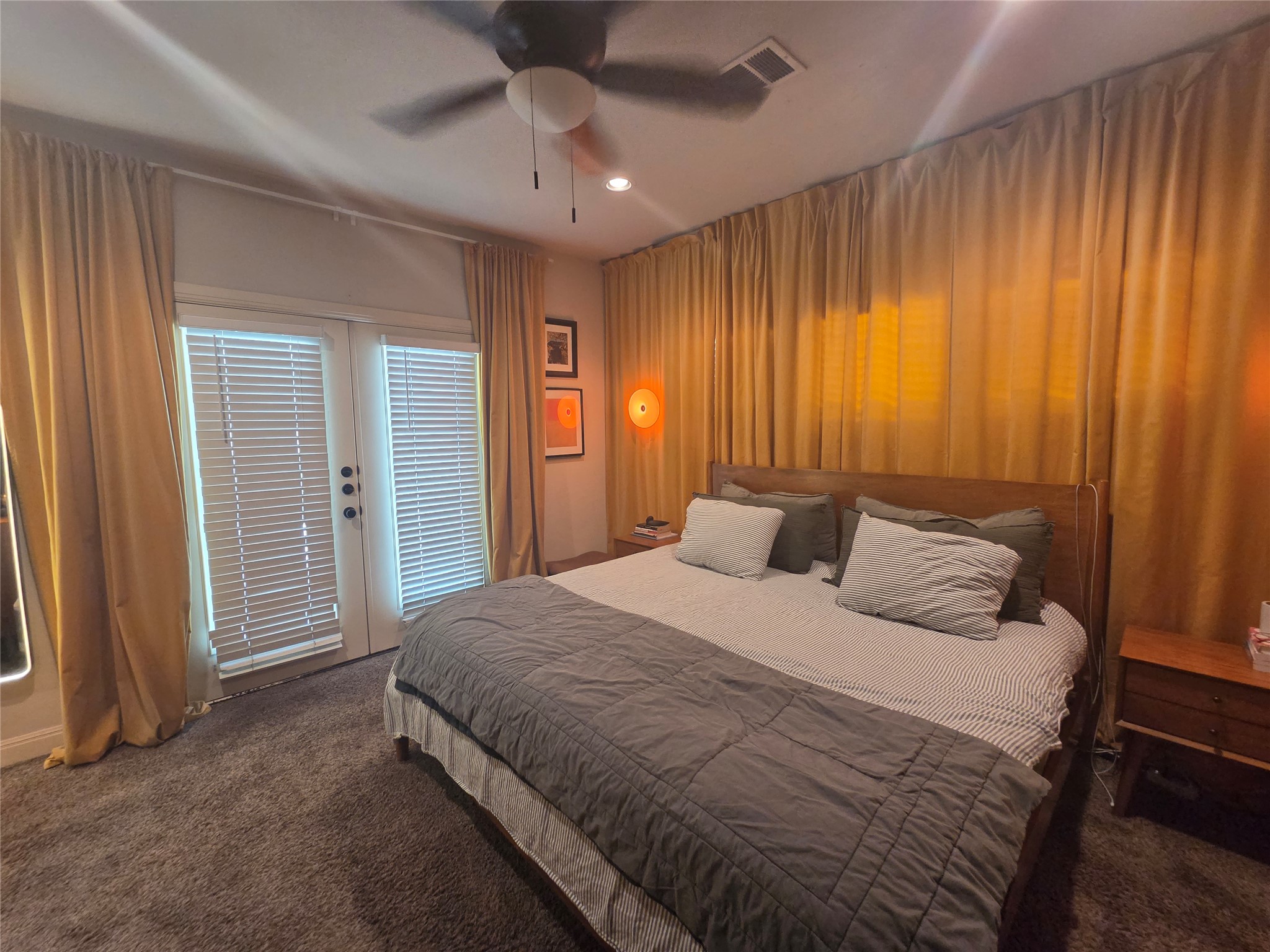 408 West Croslin Street Austin, TX 78752 - Photo 8 of 29 Comfortable bedroom with French doors leading to outdoor space.