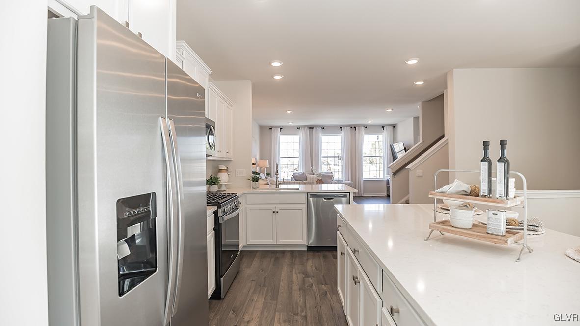 257 Winding Road Easton, PA 18040 - Photo 4 of 23 a kitchen with a sink a refrigerator and cabinets