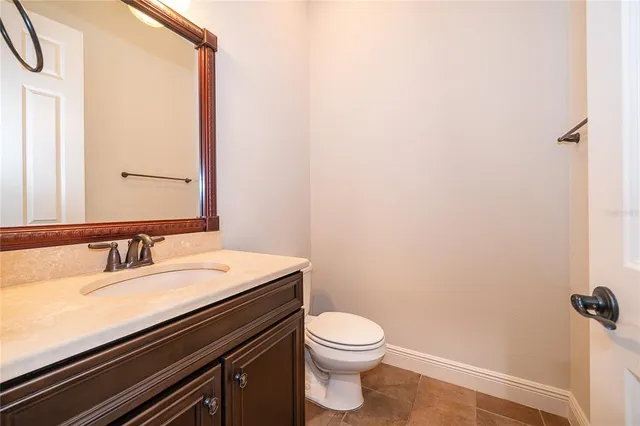 a bathroom with a sink a toilet and mirror