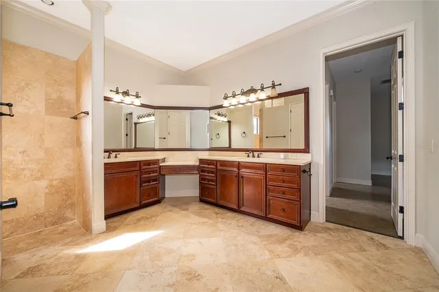 a large bathroom with a tub sink and double vanity