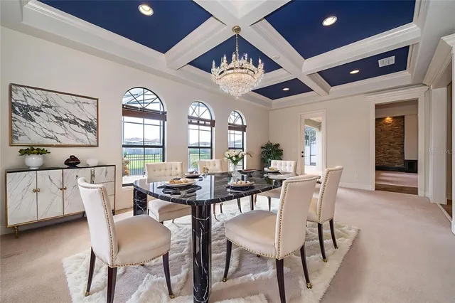 a view of a dining room with furniture and a large window